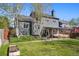 Large backyard with lawn, patio, and view of the house, featuring a covered patio at 11446 W 105Th Dr, Broomfield, CO 80021