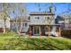 Landscaped backyard with covered patio, lawn, and garden beds at 11446 W 105Th Dr, Broomfield, CO 80021
