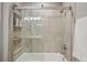 Bright bathroom showcasing a shower with neutral tile surround and glass doors at 11446 W 105Th Dr, Broomfield, CO 80021