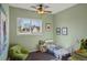 Charming Bedroom with green walls, comfortable seating, white crib, and a view of the outdoors through a window at 11446 W 105Th Dr, Broomfield, CO 80021