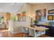 An open-concept layout featuring a dining room seamlessly connected to the kitchen area, bathed in natural light at 11446 W 105Th Dr, Broomfield, CO 80021