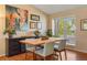 Bright dining room featuring a wooden table, neutral walls, and a window offering natural light at 11446 W 105Th Dr, Broomfield, CO 80021