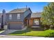 A charming two-story home with a well-kept lawn and a gray exterior paint, accented by a brick porch at 11446 W 105Th Dr, Broomfield, CO 80021