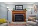 Close-up of a fireplace with wooden mantle and artwork above it in the living room at 11446 W 105Th Dr, Broomfield, CO 80021
