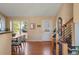 Bright foyer with hardwood floors, a staircase, and a decorative front door, creating a warm welcome at 11446 W 105Th Dr, Broomfield, CO 80021