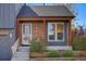 Inviting front porch with brick accents and wood trim, complementing the home's exterior at 11446 W 105Th Dr, Broomfield, CO 80021