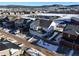 Aerial view of a two-story house with a two-car garage in a snow covered neighborhood at 2866 Low Meadow Blvd, Castle Rock, CO 80109