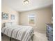 Bright bedroom with striped bedding and a dresser at 2866 Low Meadow Blvd, Castle Rock, CO 80109