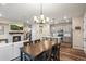 Open concept dining area with kitchen, island, and hardwood floors at 2866 Low Meadow Blvd, Castle Rock, CO 80109