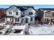 Two-story home with white siding, snowy front yard, and attached garage at 2866 Low Meadow Blvd, Castle Rock, CO 80109