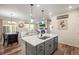 Open kitchen with island, stainless steel appliances, and hardwood floors at 2866 Low Meadow Blvd, Castle Rock, CO 80109