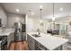 Modern kitchen with gray cabinets, quartz countertops, and stainless steel appliances at 2866 Low Meadow Blvd, Castle Rock, CO 80109