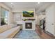 Living room with fireplace, sectional sofa, and hardwood floors at 2866 Low Meadow Blvd, Castle Rock, CO 80109