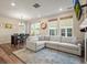 Spacious living room with L-shaped sofa, fireplace, and large windows at 2866 Low Meadow Blvd, Castle Rock, CO 80109