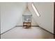 Spacious attic room with a desk, chair, and windows providing natural light at 8691 S Warhawk Rd, Conifer, CO 80433