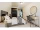 Stylish bedroom with a desk, round mirror, and soft bedding, creating a relaxing atmosphere at 8691 S Warhawk Rd, Conifer, CO 80433