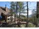 Expansive deck with outdoor seating, grill, and mountain views at 8691 S Warhawk Rd, Conifer, CO 80433