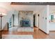 Living room features a stone fireplace, hardwood floors and access to the kitchen at 8691 S Warhawk Rd, Conifer, CO 80433