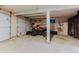 Spacious garage area features ample space for parking and storage, with easy access to outdoor equipment at 8691 S Warhawk Rd, Conifer, CO 80433