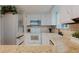 Kitchen with white cabinets, stainless steel fridge and ample countertop space at 8691 S Warhawk Rd, Conifer, CO 80433