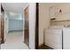 Convenient laundry area adjacent to the hallway includes modern machines and ample storage space at 8691 S Warhawk Rd, Conifer, CO 80433