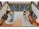 A high angle shows the seating in the living room with a large window and vaulted ceilings at 8691 S Warhawk Rd, Conifer, CO 80433