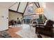 Inviting living room with vaulted ceilings and a wall of windows offering stunning mountain views at 8691 S Warhawk Rd, Conifer, CO 80433