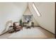 Bright office space with vaulted ceilings, white walls, and a unique accent window at 8691 S Warhawk Rd, Conifer, CO 80433
