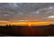 Beautiful sunset over mountain range with a cloudy sky at 8691 S Warhawk Rd, Conifer, CO 80433