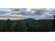 A beautiful, distant view of the mountains beneath a bright rainbow at 8691 S Warhawk Rd, Conifer, CO 80433
