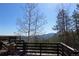 Scenic view from the wooden deck showcasing blue sky and distant mountains at 8691 S Warhawk Rd, Conifer, CO 80433