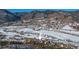 Aerial view of house amongst other homes in a wintery setting at 110 Oakdale Dr, Palmer Lake, CO 80133