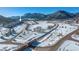 Aerial view of property near a train track and mountain range at 110 Oakdale Dr, Palmer Lake, CO 80133