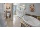 Elegant bathroom featuring a large soaking tub and double vanity at 110 Oakdale Dr, Palmer Lake, CO 80132