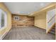 Finished basement space with exposed wood accent wall and neutral carpeting at 16185 Willowstone St, Parker, CO 80134