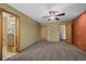 Spacious bedroom features neutral carpeting, ceiling fan, and attached bathroom and walk-in closet at 16185 Willowstone St, Parker, CO 80134