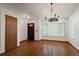 Bright entryway boasts hardwood floors, white walls, and a decorative chandelier, creating a welcoming ambiance at 16185 Willowstone St, Parker, CO 80134