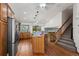 Spacious kitchen features stainless steel appliances, an island with seating, and stairs to the upper level at 16185 Willowstone St, Parker, CO 80134