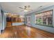 Open concept living room with hardwood floors, stairs to the kitchen, and access to patio at 16185 Willowstone St, Parker, CO 80134