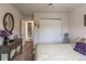 Bright bedroom featuring a bed, closet, and a view of an adjoining bathroom at 10640 W 46Th Ave, Wheat Ridge, CO 80033