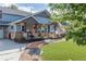 Inviting front porch with swing, lush landscaping, and charming curb appeal at 10640 W 46Th Ave, Wheat Ridge, CO 80033