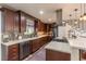 Updated kitchen showcasing stainless steel appliances, dark wood cabinets, and a mosaic backsplash at 10640 W 46Th Ave, Wheat Ridge, CO 80033