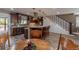 Beautiful kitchen with a large island, wood cabinets, pendant lighting, and stairs to a second floor at 10640 W 46Th Ave, Wheat Ridge, CO 80033