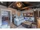 Inviting living room featuring dark wood ceilings, a comfortable sofa, and an open layout to the kitchen at 10640 W 46Th Ave, Wheat Ridge, CO 80033