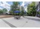 Spacious concrete patio, with outdoor dining under blue umbrellas and lush greenery at 10640 W 46Th Ave, Wheat Ridge, CO 80033