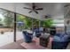 Spacious covered patio featuring comfortable seating, ceiling fans, and a grill at 10640 W 46Th Ave, Wheat Ridge, CO 80033