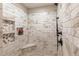 Modern shower with marble tile, a built-in niche, a corner seat, and a sleek shower fixture at 10640 W 46Th Ave, Wheat Ridge, CO 80033