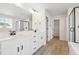 Bathroom featuring double vanity with white cabinets, walk-in glass shower, and modern fixtures at 4046 N Irvington St, Aurora, CO 80019