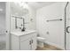 Bathroom with sleek black hardware, white vanity, and a glass-enclosed shower at 4046 N Irvington St, Aurora, CO 80019