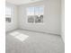 Bright bedroom featuring plush carpeting, neutral tones, and large windows for lots of light at 4046 N Irvington St, Aurora, CO 80019
